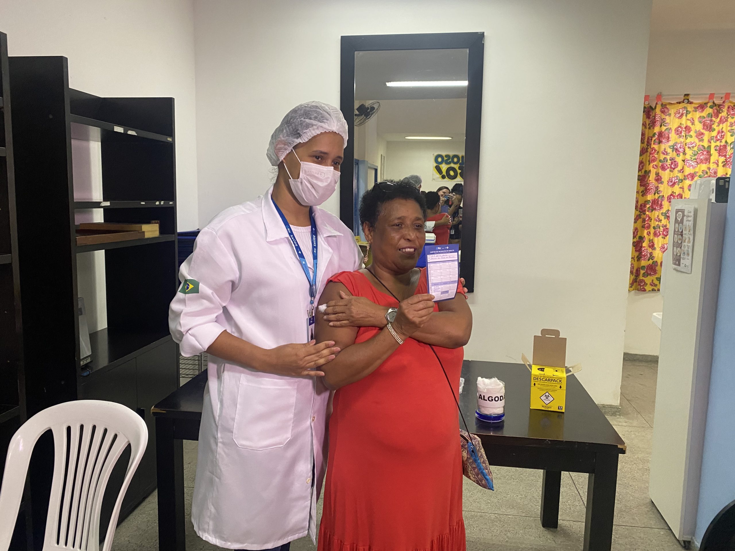 Filha vacina a própria mãe durante campanha contra a gripe
