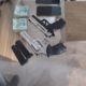 armas e dinheiro apreendidos em um dos endereços ligados a policiais militares envolvidos no esquema de tráfico de armas e caça-níqueis