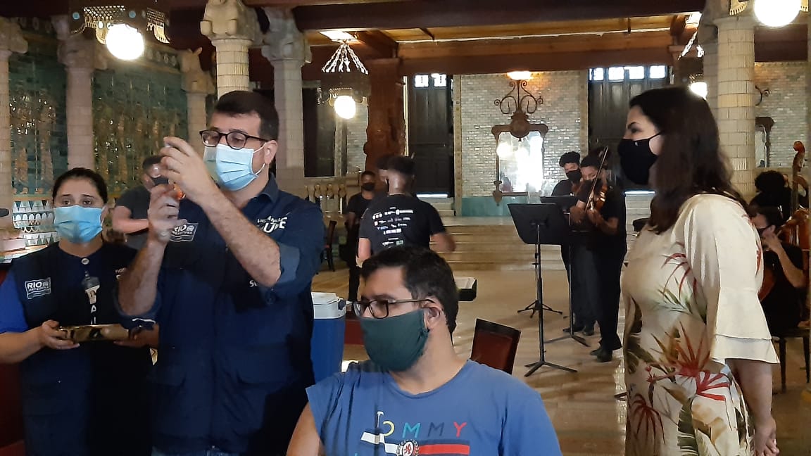 Daniel Soranz preparando para vacina para uma pessoa no Teatro Municipal, ao lado da Secretária de Estado de Cultura Danielle Barros